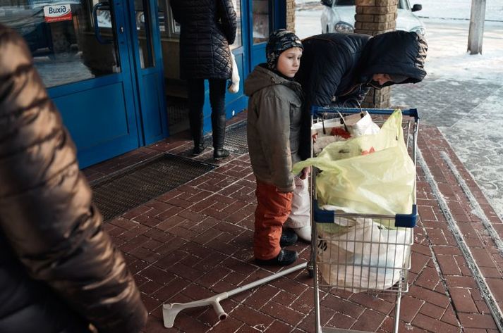 Alla, with her son, after receiving groceries paid for by Svitanok in 2016. HIV-positive, she fled her home just outside of Donetsk amid fighting and is now living with her son in Kramatorsk. Ukraine, 2016.